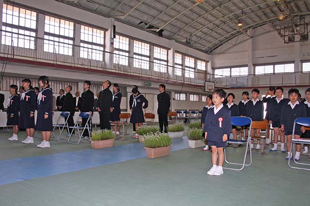 効果を斉唱する新入生と在校生